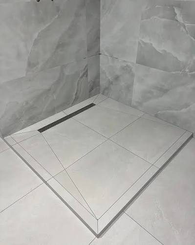 Shower floor slope to the drain and sealed junctions